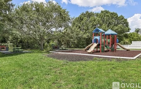 A playground with a slide and a swing set.