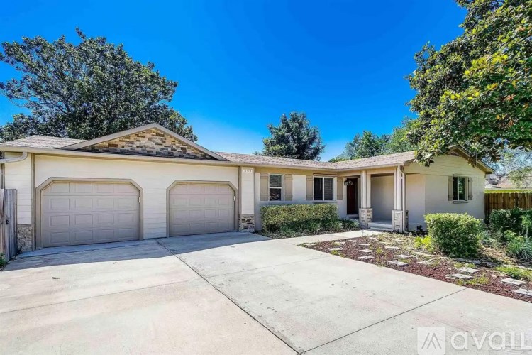 A house with a white garage door is for sale.
