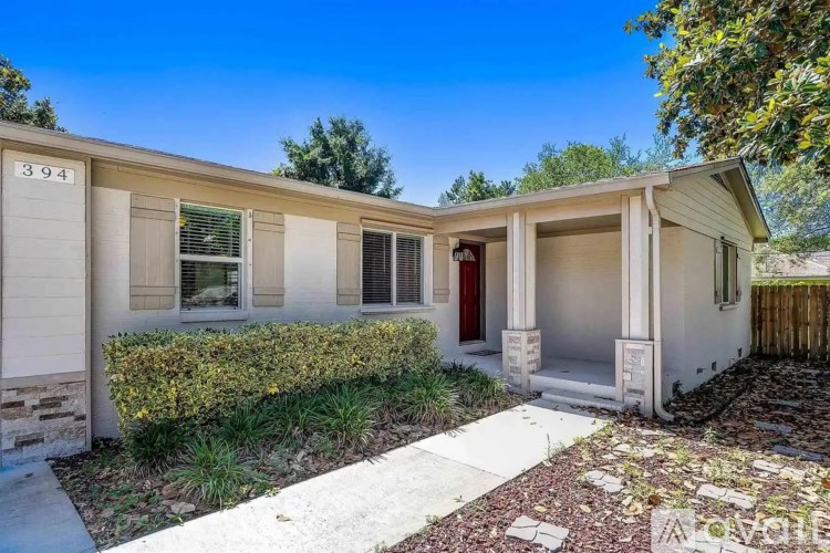 A house numbered 3944 is shown with a red door and a white fence.