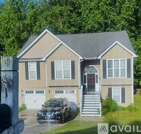 A house with a car parked in front of it.