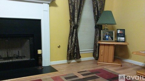 A living room with a fireplace and a TV on a stand.