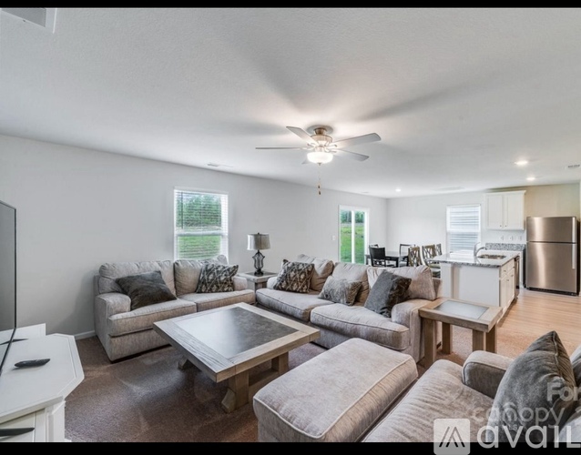 A living room with a grey couch and a wooden coffee table.