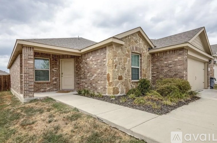 A house with a stone wall on the side.