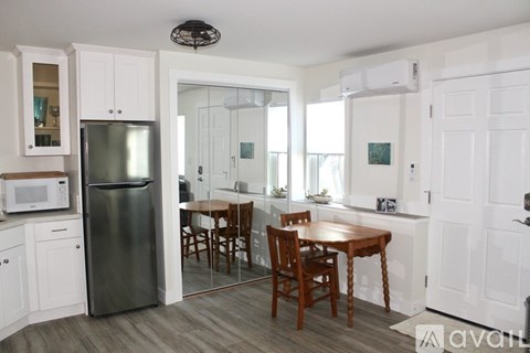 A kitchen with a table and chairs in the middle of the room.
