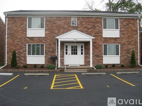A brick building with a white door and windows.
