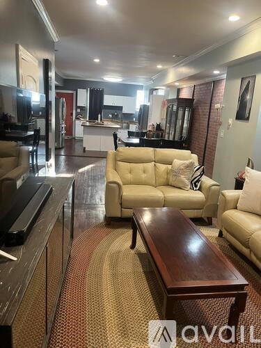 A living room with a couch, a coffee table, and a television.