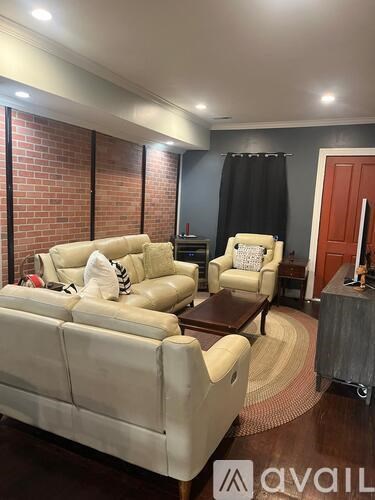 A living room with a white couch and a brown coffee table.