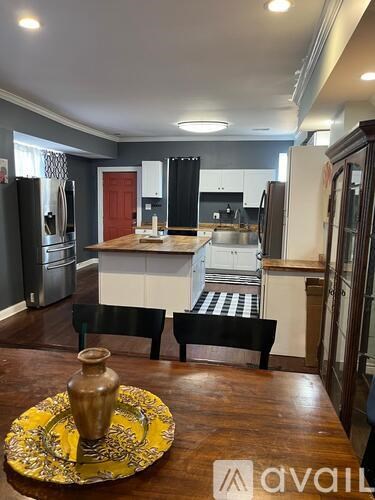 A kitchen with a table set for two in the middle.
