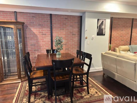 A dining room with a wooden table and chairs.