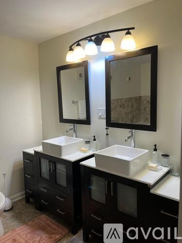 A bathroom with two sinks and a large mirror.