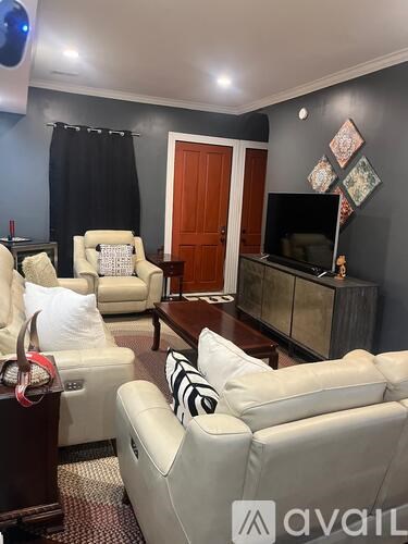 A living room with a white sofa and a wooden cabinet.