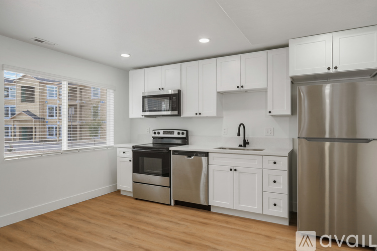 A kitchen with white cabinets and stainless steel appliances.