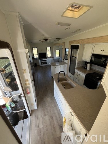The interior of a vehicle with a kitchen area.