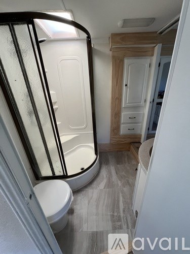 A bathroom with a toilet, sink, and mirror.