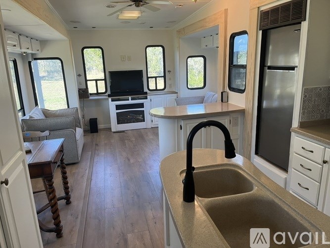 A kitchen area with a sink, stove, and refrigerator.