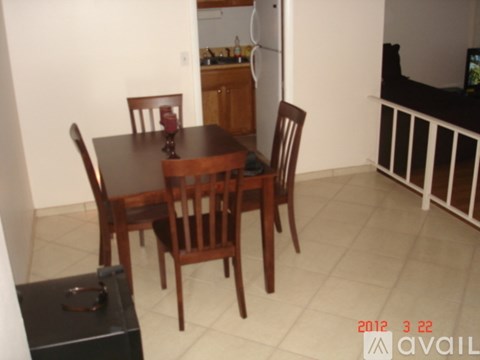 A dining room with a table and chairs.