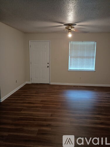 A room with a ceiling fan and a window.