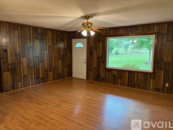 A room with wooden walls and a white door.