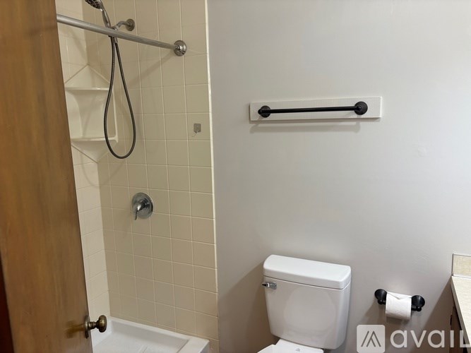 A white toilet sits next to a white sink in a small bathroom.