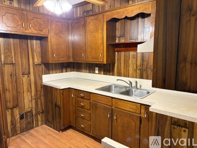 A kitchen with wooden cabinets and a white countertop.