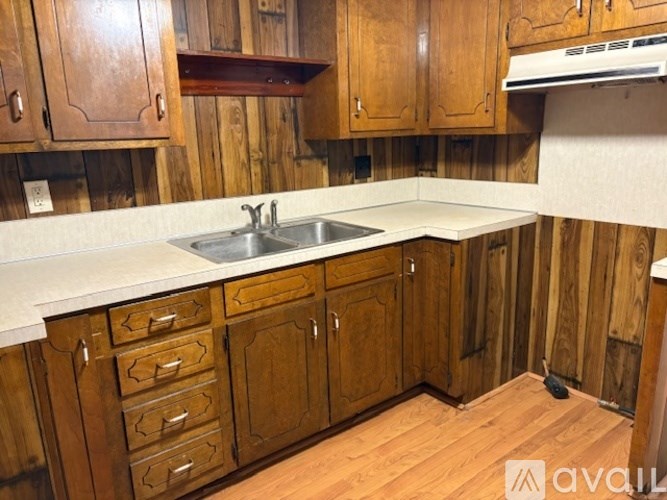 A kitchen with wooden cabinets and a white countertop.