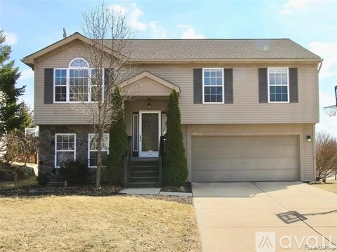 A two-story house with a garage is for sale.