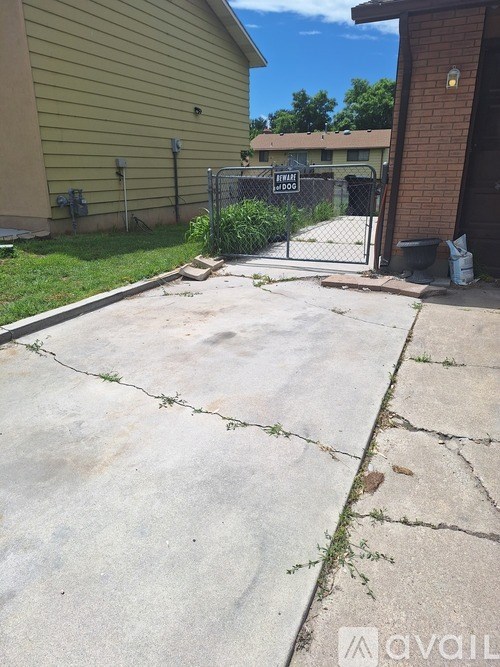 A concrete driveway leads to a house with a sign that says "DRIVEWAY LOCATION".