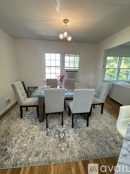 A dining room with a table set for six.