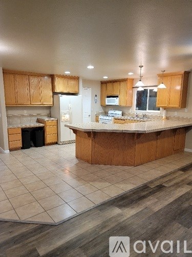 A kitchen with wooden cabinets and a central island.