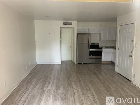 A kitchen with a refrigerator, oven, and microwave is available for rent.