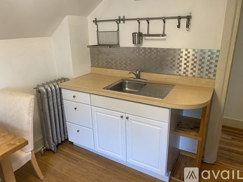 A kitchen with a sink and a wooden counter.