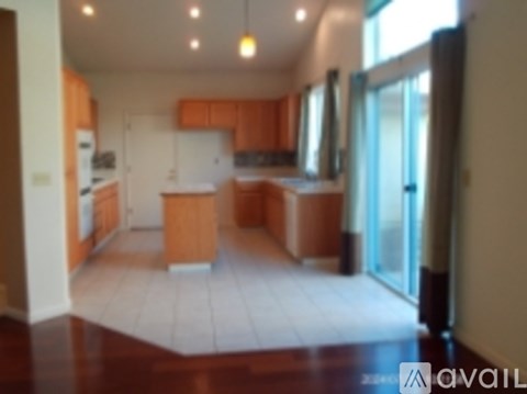 A kitchen with wooden cabinets and a white fridge.