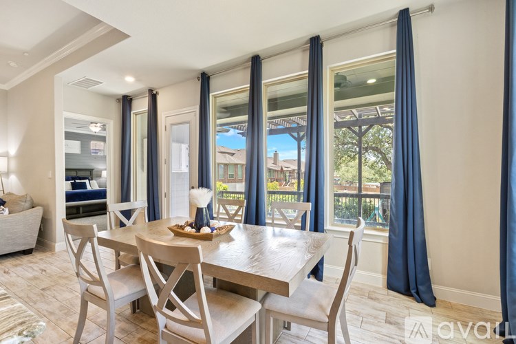 A dining room with a table set for four.
