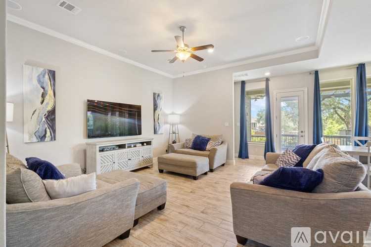 A living room with a grey couch and a white entertainment center.