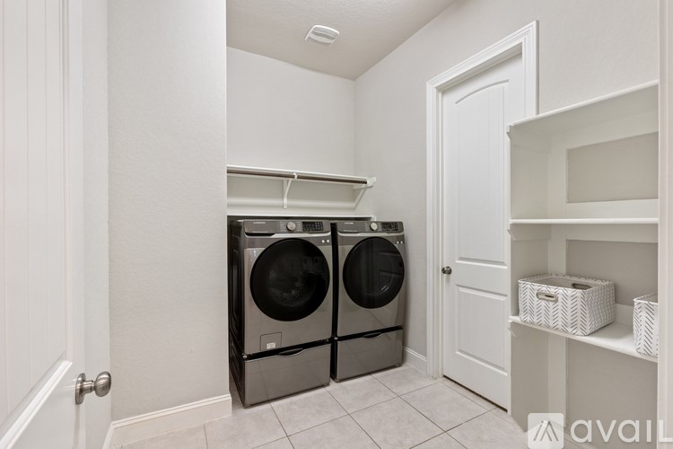A laundry room with two front loading washing machines.