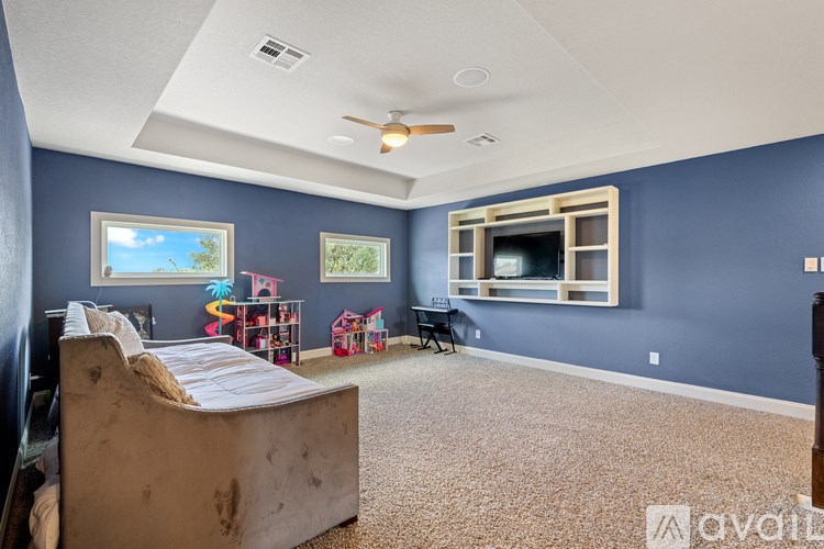 A bedroom with a bed, a chair, and a window.