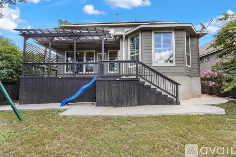 A house with a blue slide in the front yard.