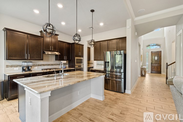A modern kitchen with wooden cabinets and a central island.