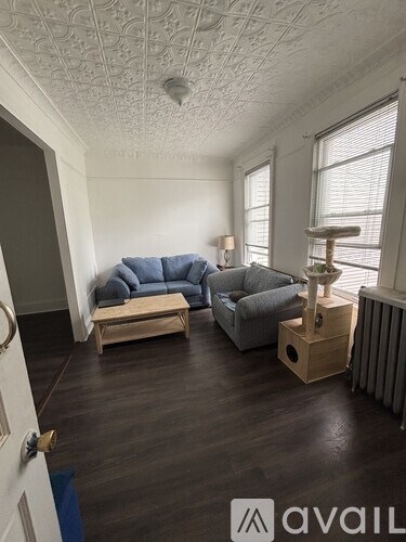A living room with a grey couch and a wooden table.