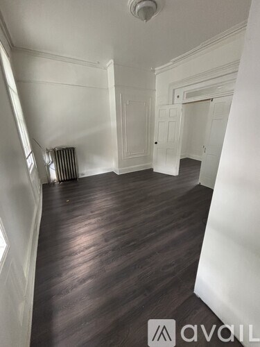 A room with wooden floors and white walls.
