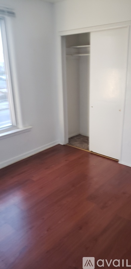 A room with a wooden floor and white walls.