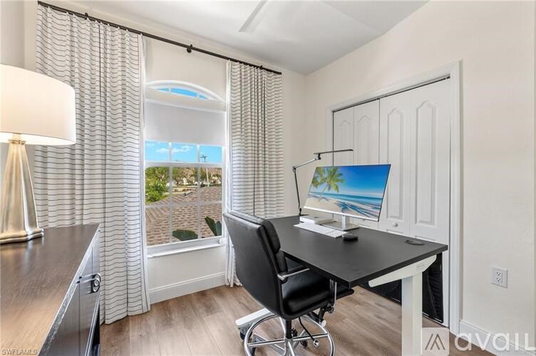 A room with a desk, chair, and a window with blinds.