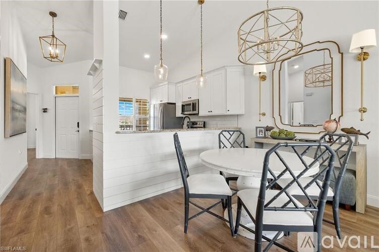 A modern kitchen with a dining table and chairs.