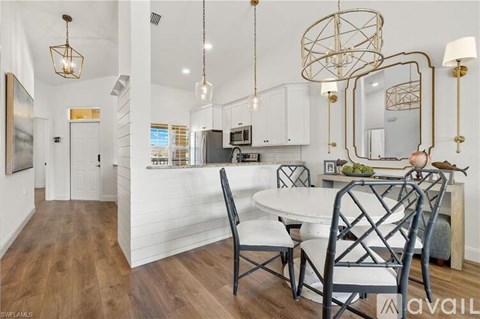 A modern kitchen with a dining table and chairs.