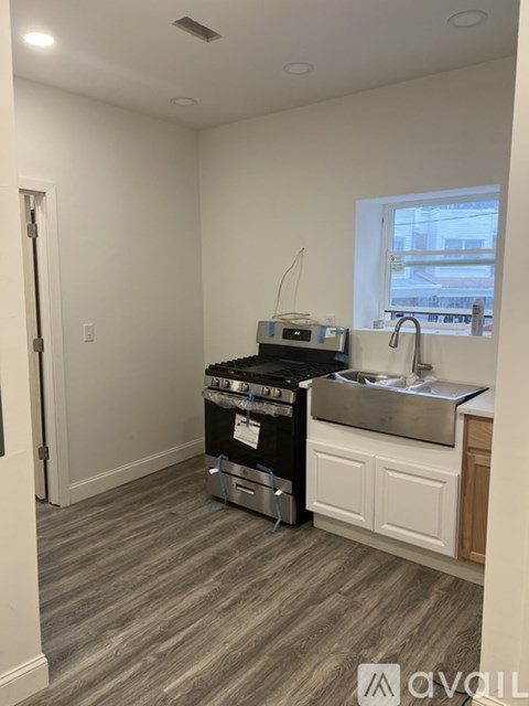 A small kitchen with a stove and sink.