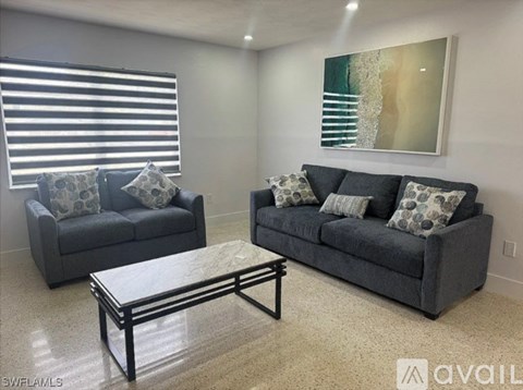A living room with two grey couches and a coffee table.