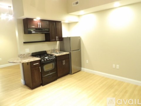 A kitchen with wooden cabinets and a stove top oven.