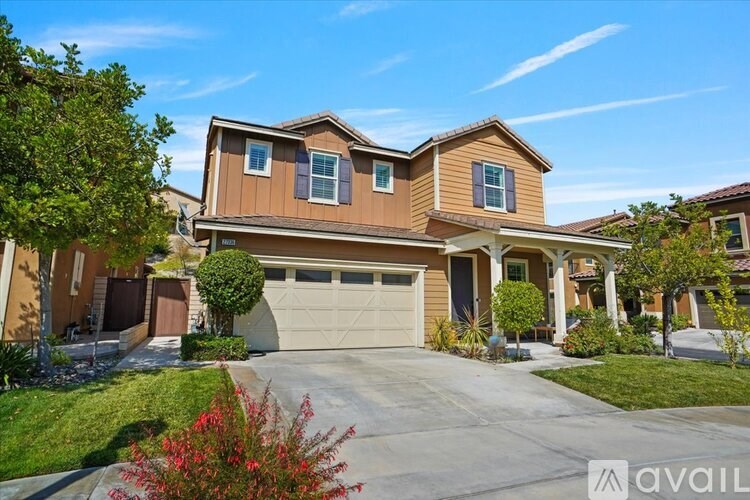 A house with a brown and tan exterior is for sale.