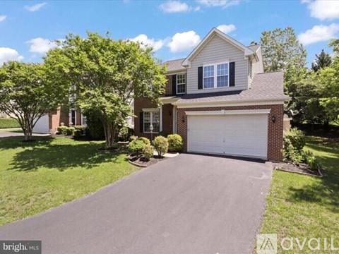 A house with a driveway and garage is for sale.