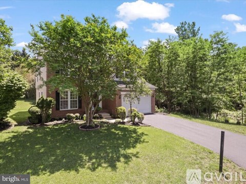 A house with a tree in front of it.